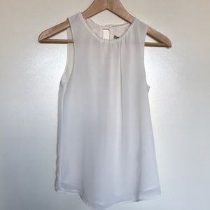 off-white Top with cute back detail!